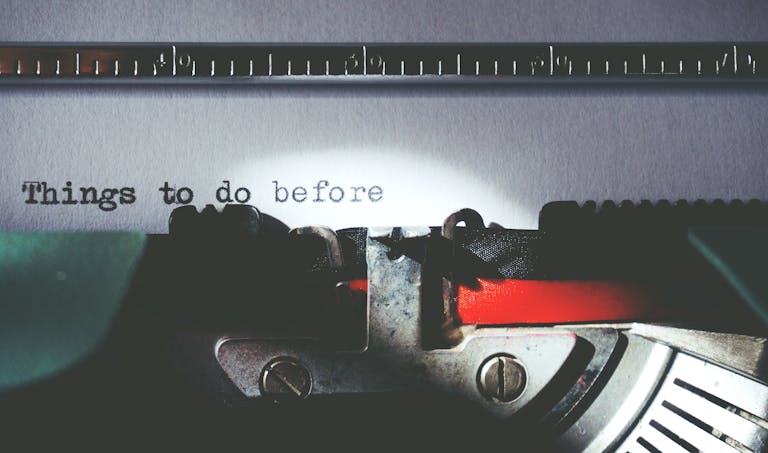 Close-up of a vintage typewriter typing 'Things to do before'.